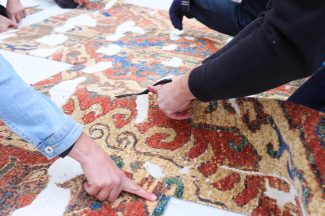 The 'CulturalxCollabs' carpet being cut at the launch event.© Museum für Islamische Kunst / Don Panakkal